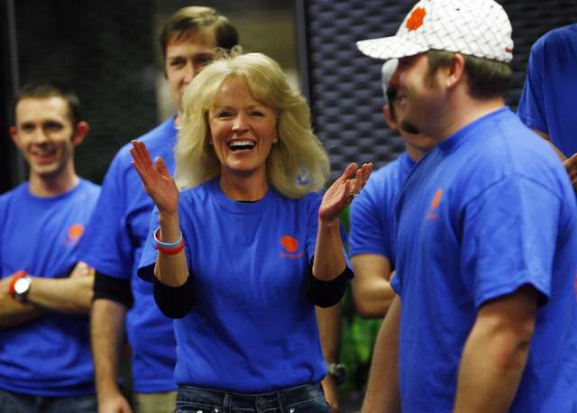 Mary Scott, president of Fishbowl, claps her hands as the employees dance during a party after David Williams, CEO of Fishbowl, handed the president of Zions Bank a check for $1 million, paying off the company's loan Thursday, Dec. 29, 2011, at Fishbowl's headquarters in Orem.