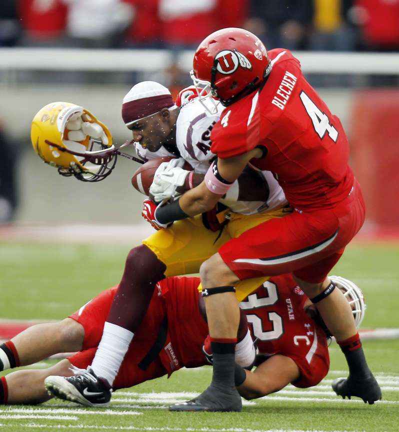 Arizona State Sun Devils wide receiver Gerell Robinson has his helmet knocked off as he is sandwiched Brian Blechen and Chaz Walker of Utah as the University of Utah faces Arizona State in NCAA football in Salt Lake City, Saturday, Oct. 8, 2011. (Ravell Call, Deseret News)