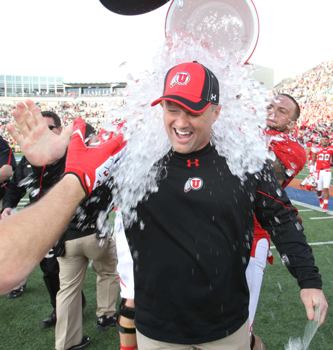 Utah head coach Kyle Whittingham gets dunked after defeating Georgia Tech in the Sun Bowl NCAA college football game on Saturday, Dec. 31, 2011, in El Paso, Texas. Utah won 30-27 in overtime. (AP Photo/El Paso Times, Ruben R Ramirez)