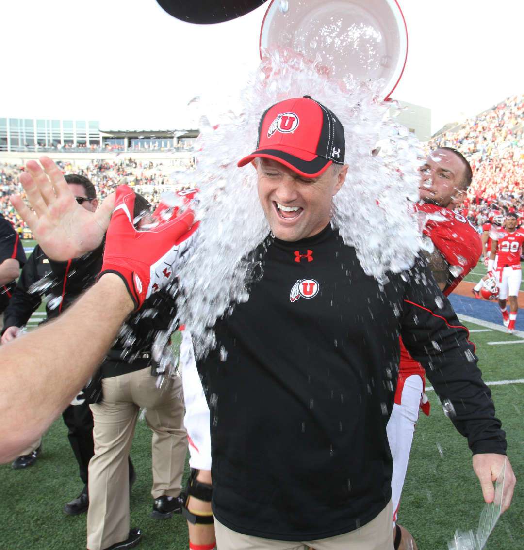 Utah head coach Kyle Whittingham gets dunked after defeating Georgia Tech in the Sun Bowl NCAA college football game on Saturday, Dec. 31, 2011, in El Paso, Texas. Utah won 30-27 in overtime. (AP Photo/El Paso Times, Ruben R Ramirez)