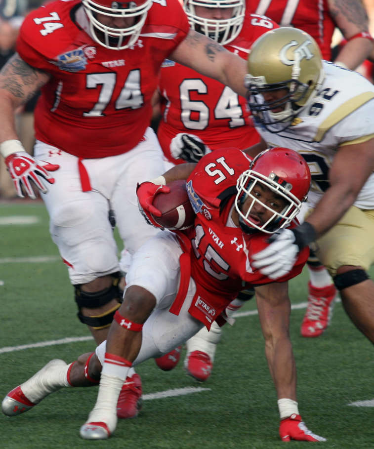 Utah's John White, bottom, struggles to reach the goal line as Georgia Tech's Jason Peters brings him down during overtime the Sun Bowl NCAA college football game on Saturday, Dec. 31, 2011, in El Paso, Texas. Utah won 30-27 in overtime. (AP Photo/El Paso Times, Victor Calzada)