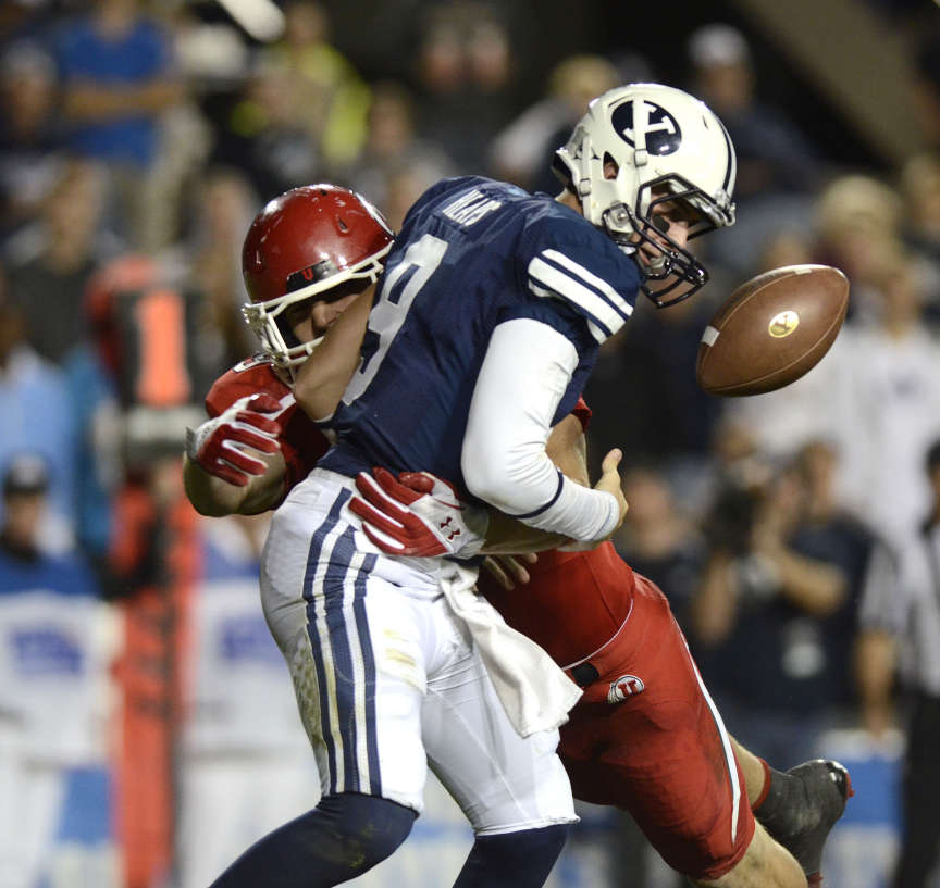 Brigham Young Cougars quarterback Jake Heaps (9) has the ball knocked loose by Utah Utes linebacker Trevor Reilly (49) as the University of Utah and Brigham Young University play football Saturday, Sept. 17, 2011, in Provo, Utah. (Nate Sorensen, Deseret News)