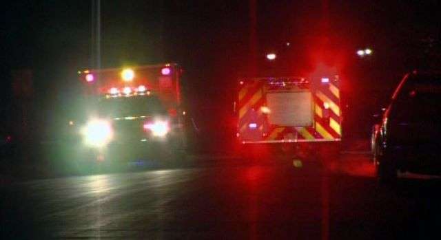 Ambulances wait outside the Ogden residence where six officers were shot while serving a drug warrant Jan. 4. One of the officers, Jared Francom, died from his injuries.