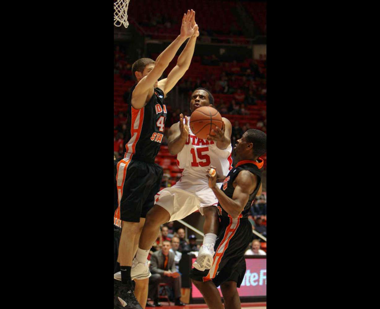 Josh Watkins, of Utah, puts up a shot under defense from Dejan Kostur, of ISU, left, and Kenny McGowen, of ISU, right, as the University of Utah faces Idaho State University in men's basketball in Salt Lake City, Friday, Dec. 16, 2011. (Ravell Call, Deseret News)