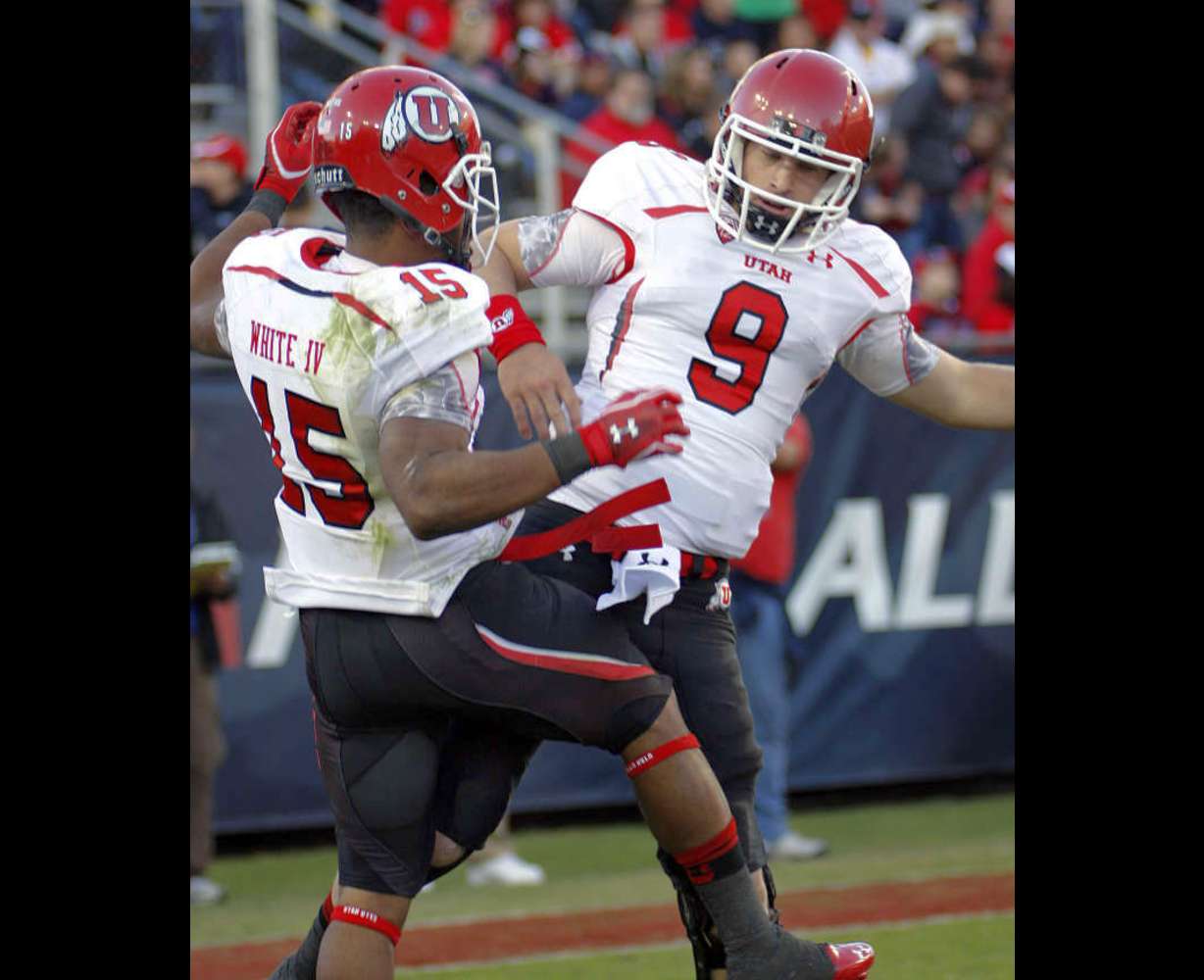 Utah's John White (15) and quarterback Jon Hays (9) celebrate in the end zone after a touchdown by Hays in the first quarter of an NCAA college football game in Tucson, Ariz., Saturday, Nov. 5, 2011. (AP Photo/Wily Low)