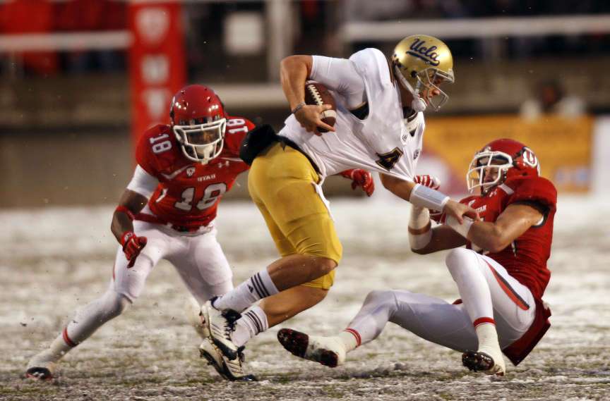 Utah Utes linebacker Brian Blechen (4) and Utah Utes defensive back Eric Rowe (18) tackle UCLA Bruins quarterback Kevin Prince (4) as the University of Utah plays UCLA in Salt Lake City. (Tom Smart, Deseret News)