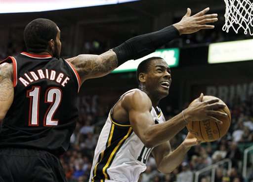 Utah Jazz guard Alec Burks (10) goes for a shot
past Portland Trail Blazers forward LaMarcus
Aldridge (12). (AP Photo/Jim Urquhart)