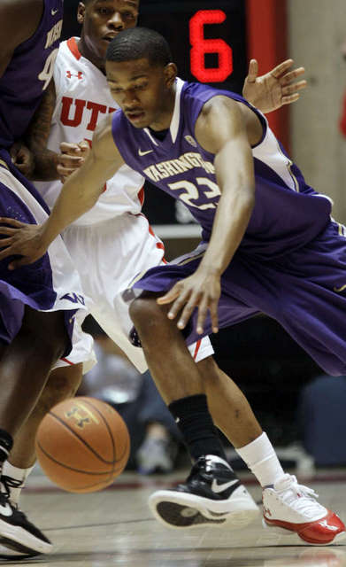 Washington Huskies guard C.J. Wilcox (23) tries 
to control the ball against Utah. (Deseret 
News)