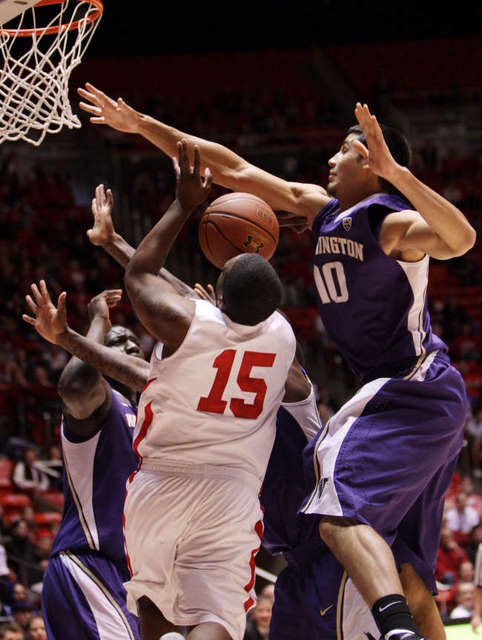 Utah Utes guard Josh Watkins (15) has his shot 
blocked by Washington Huskies forward Martin 
Breunig (10). (Deseret News)