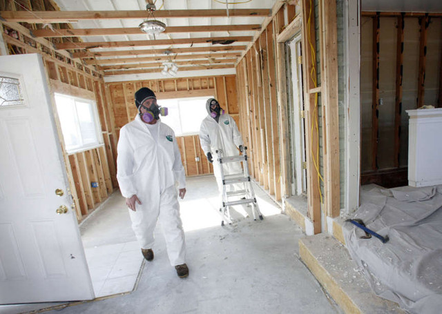 Homeowner Art Samples and Derek Clay, with Utah Crime Scene Cleaners, clean out a meth house in West Valley City on Monday, Jan. 9, 2012. Habitat for Humanity and Utah Crime Scene Cleaners are helping to make the house safe to live in again.