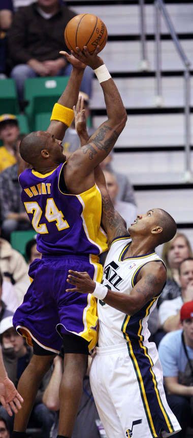 Kobe Bryant, of LA, left, shoots over Raja Bell, of Utah, as the Los Angeles Lakers face the Utah Jazz in NBA basketball in Salt Lake City, Wednesday, Jan. 11, 2012. (Ravell Call, Deseret News)