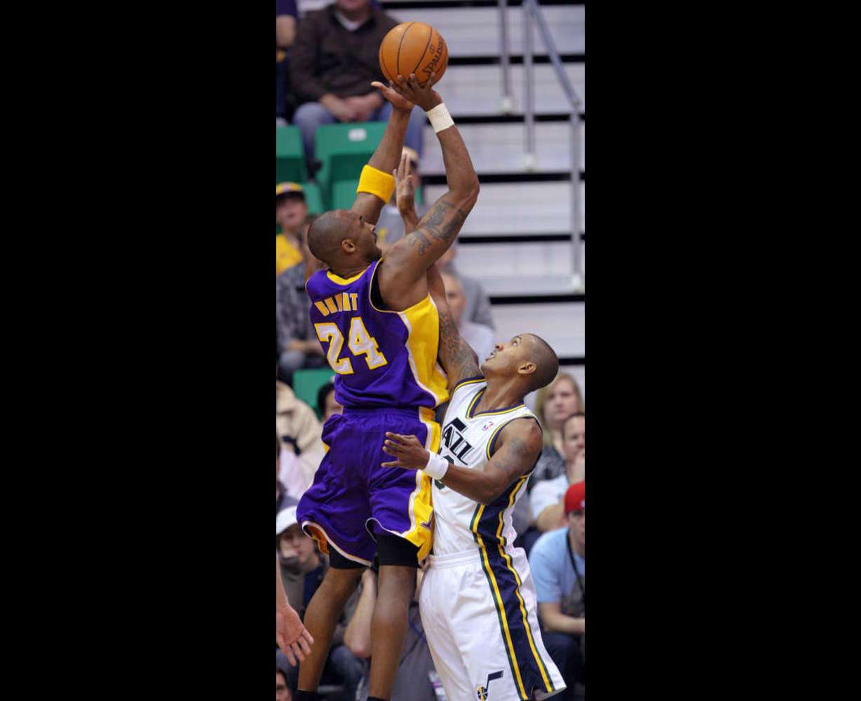 Kobe Bryant, of LA, left, shoots over Raja Bell, of Utah, as the Los Angeles Lakers face the Utah Jazz in NBA basketball in Salt Lake City, Wednesday, Jan. 11, 2012. (Ravell Call, Deseret News)