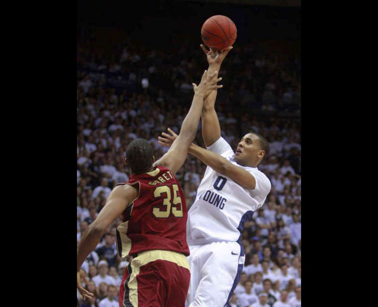 BYU's #0 Brandon Davies looks puts up a shot
over Santa Clara's #34 Robert Garrett. (Deseret
News)