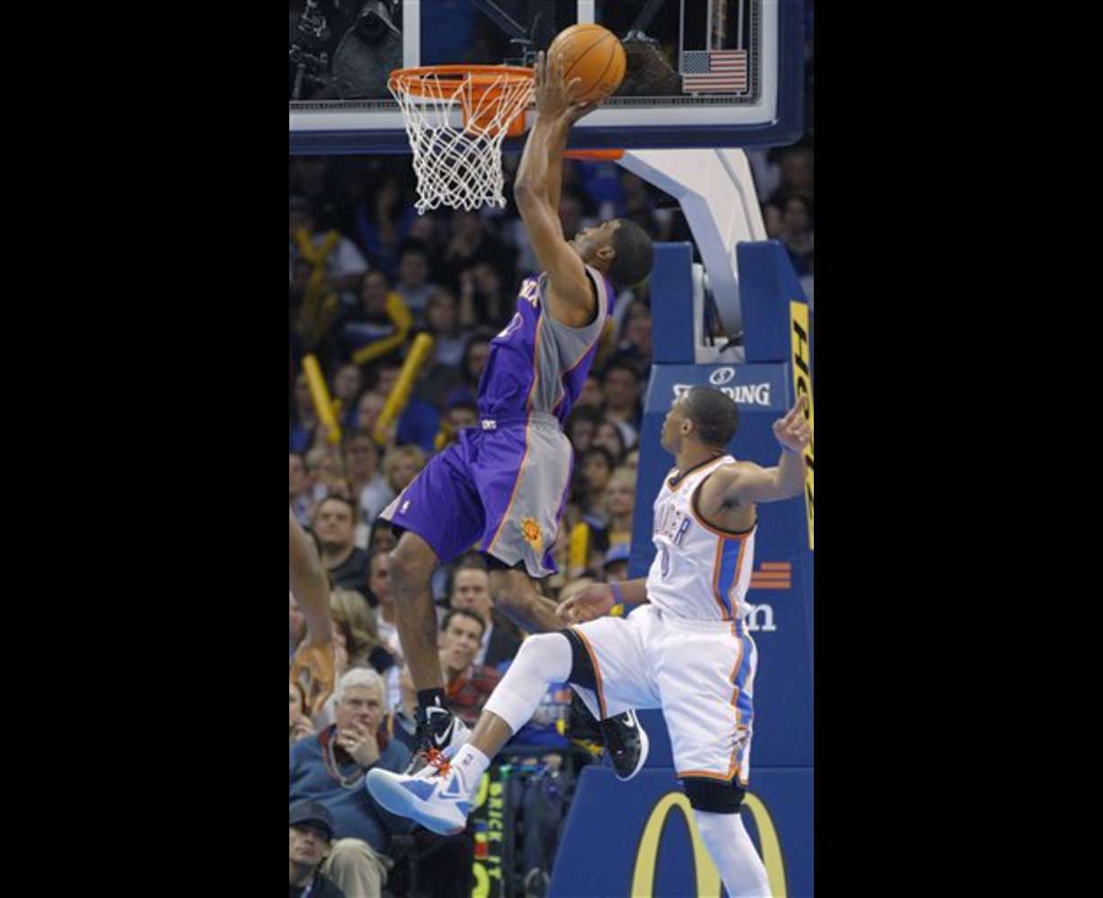 Phoenix Suns guard Ronnie Price, left, shoots
in front of Oklahoma City Thunder guard Russell
Westbrook. (AP Photo/Sue Ogrocki)