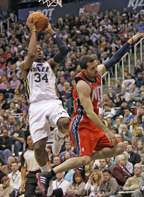 Utah's C. J. Miles shoots over Jordan Farmar as 
the Utah Jazz defeat the New Jersey Nets 107-
94. (Deseret News)
