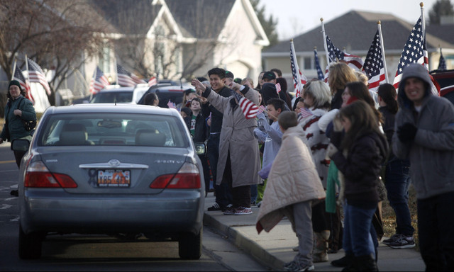 A crowd eagerly waits to honor Anthony Peterson as he arrives home from Afghanistan in Orem on Monday, Jan. 16, 2012.