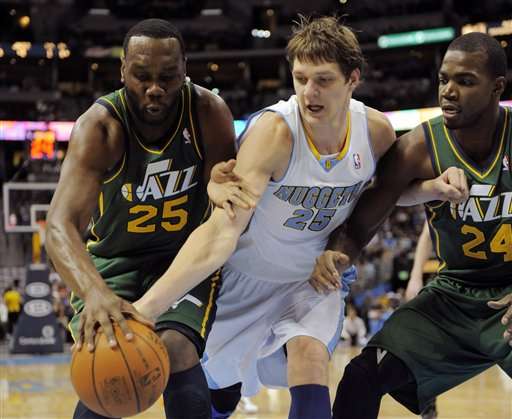 Utah Jazz center Al Jefferson (25), Denver
Nuggets center Timofey Mozgov (25) and Paul
Millsap (24) go after a loose ball. (AP
Photo/Jack Dempsey)
