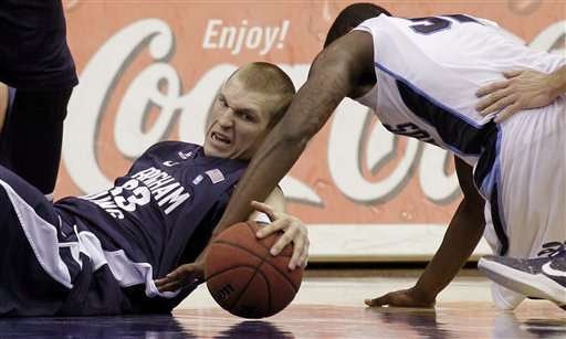 Brigham Young's Nate Austin, left, battles San
Diego's Ken Rancifer for a loose ball. (AP
Photo/Gregory Bull)