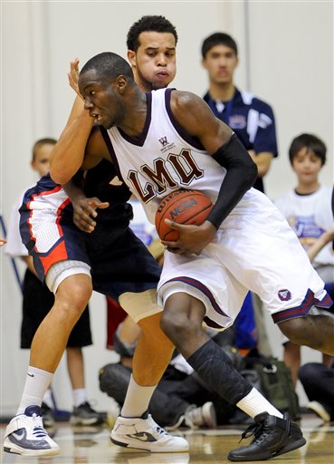 Loyola Marymount forward Ashley Hamilton 
attempts to drive past Gonzaga forward Elias 
Harris. (AP Photo/Gus Ruelas)