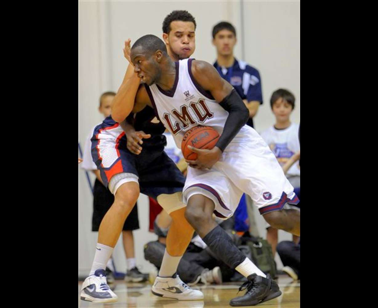 Loyola Marymount forward Ashley Hamilton
attempts to drive past Gonzaga forward Elias
Harris. (AP Photo/Gus Ruelas)