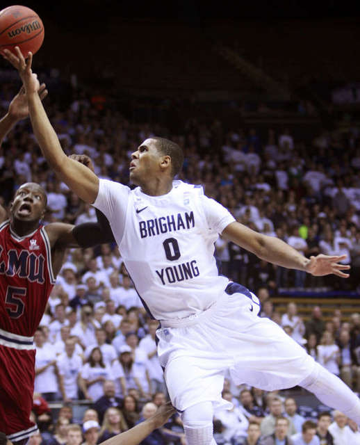 BYU's #0 Brandon Davies tries to lay in a shot
but has it blocked by Loyola Marymount's #5
Ashley Hamilton. (Deseret News)