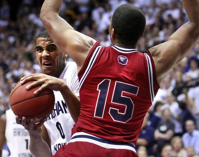 BYU's Brandon Davies can't get a shot off as
he is defended by Loyola Marymount's Alex
Osborne . BYU lost 82-68. (Deseret News)