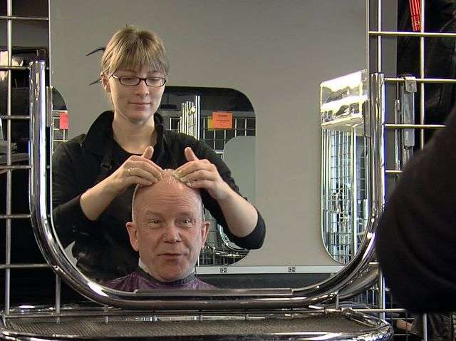 KSL's Steve Fidel receives a scalp massage from hair-styling student Kristen Killpack at Cameo
College in Murray.