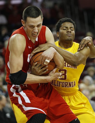 Utah's Jason Washburn, left, and USC's Alexis 
Moore (3) battle for the ball. (AP 
Photo/Lori Shepler)