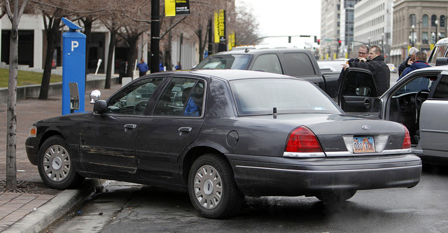 Sgt. Bruce Timothy of the Motor Vehicle Enforcement Division, pointing, describes what happened when his car, at front of photo, was hit during part of a chase in Salt Lake City, Thursday, Feb. 2, 2012. (Ravell Call, Deseret News)