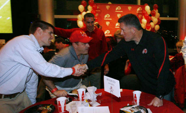 Kyle Whittingham, right, greets Richard 
Folkerson at the Utah football national letter 
of intent Crimson Club celebration. (Deseret 
News)