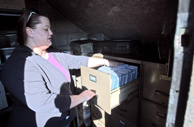 Pioneer Sawdust executive assistant Jazmyn Swainston looks at their business files that were in the fire proof safe that survived the fire at Pioneer Sawdust, 621 Fulton Street, Friday, Feb. 3, 2012, that started overnight and destroyed four buildings and damaged another. (Photo: Scott G Winterton, Deseret News)