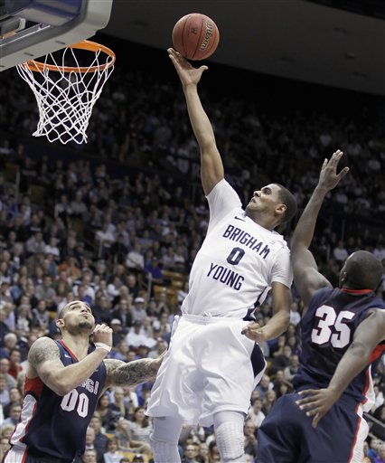 BYU's Brandon Davies, center lays a shot up
between Gonzaga's Robert Sacre, left and Sam
Dower, right. BYU beat Gonzaga 83-73. (AP
Photo/George Frey)