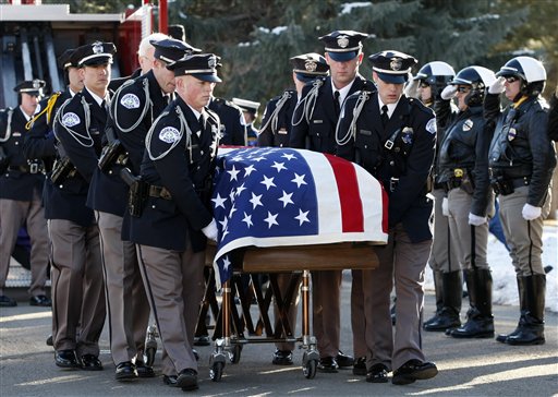 An Ogden police honor guard transfers the
casket of officer Jared Francom to the grave
site, Jan. 11 in Ogden. Francom, who was killed
in the line of duty January 4, while serving a
warrant. Five other officers were also wounded
in the shoot out. (AP Photo/Colin E Braley)