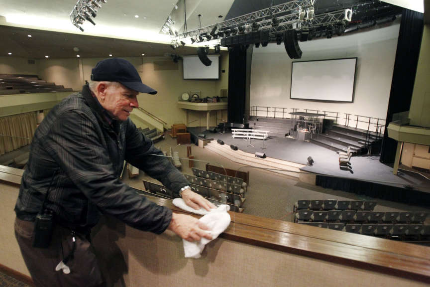 Leonid Zadniprovskiy cleans wood and glass at the Life Center Church Sanctuary in Tacoma, Washington, Friday, Feb. 10, 2012 in preparation for the memorial for Susan Cox Powell, Charlie Powell and Braden Powell. (Ravell Call, Deseret News)