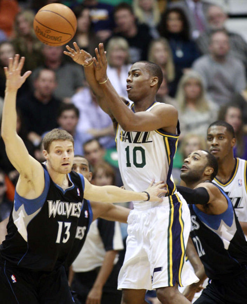 Utah Jazz guard Alec Burks (10) passes away from the defense of Minnesota Timberwolves point guard Luke Ridnour (13) and Minnesota Timberwolves guard Wayne Ellington (22) as the Utah Jazz and the Minnesota Timberwolves play Saturday, Jan. 21, 2012 in Energy Solutions Arena in Salt Lake City. (Scott G Winterton, Deseret News)