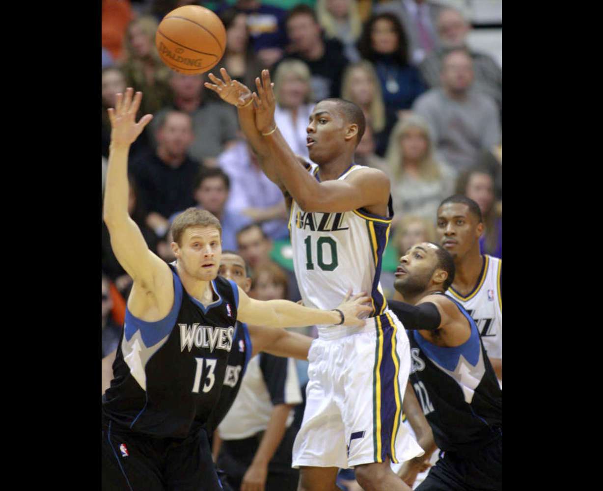 Utah Jazz guard Alec Burks (10) passes away from the defense of Minnesota Timberwolves point guard Luke Ridnour (13) and Minnesota Timberwolves guard Wayne Ellington (22) as the Utah Jazz and the Minnesota Timberwolves play Saturday, Jan. 21, 2012 in Energy Solutions Arena in Salt Lake City. (Scott G Winterton, Deseret News)