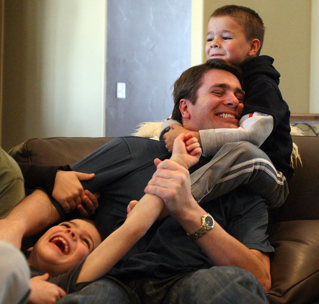 Grant Durtschi wrestles with his sons Xane, top right and Taj, in Draper, Monday, Feb. 20, 2012. 