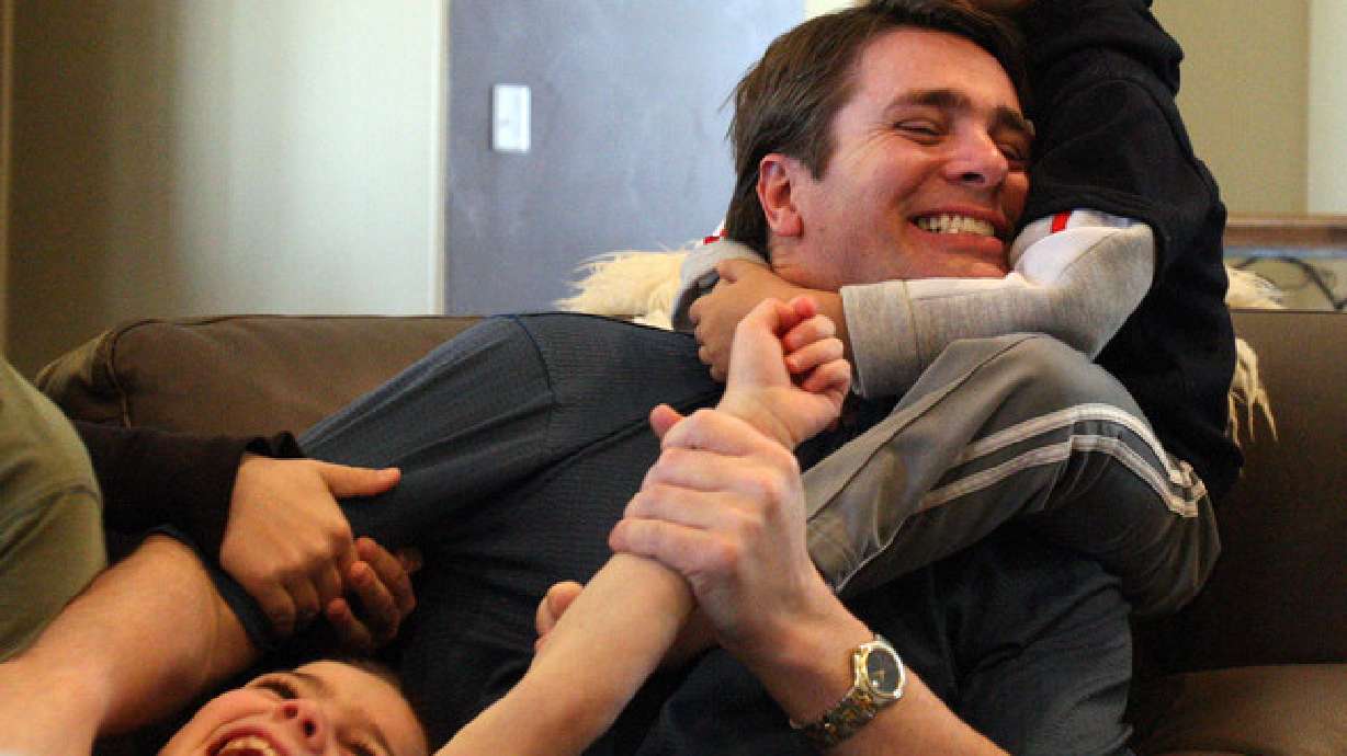Grant Durtschi wrestles with his sons Xane, top right and Taj, in Draper, Monday, Feb. 20, 2012.
