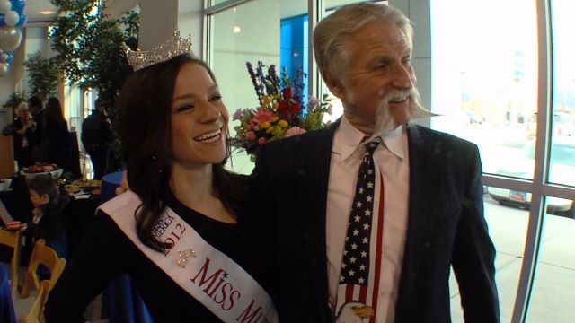 At the ceremonial opening of a new car dealership, Mallory Rogers does her duty as Miss Murray 2012. She's pictured here with Murray Mayor Dan Snarr.