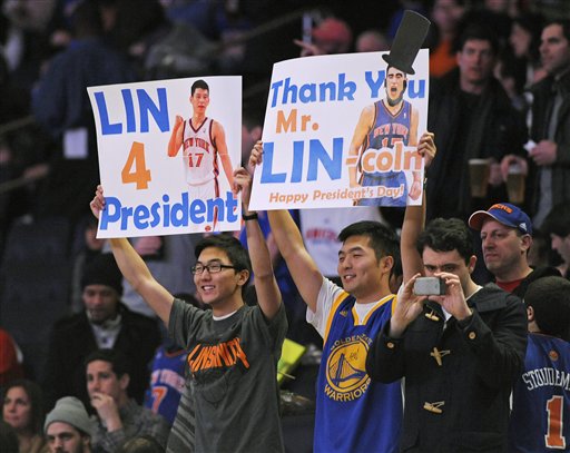 Fans hold up signs at the New York Knicks and 
New Jersey Nets game. (AP Photo/Bill Kostroun)