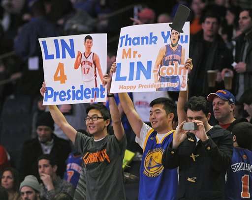 Fans hold up signs at the New York Knicks and
New Jersey Nets game. (AP Photo/Bill Kostroun)