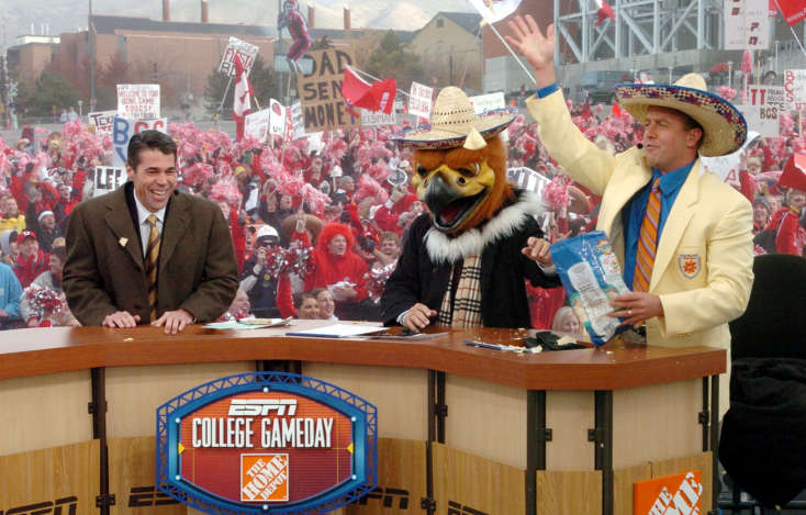 ESPN Game Day hosts (l to r) Chris Fowler, Lee Corso (in Swoop head) and Kirk Herbstreit ham it up with a bag of Tostitos and sombreros as they make reference to the Utes beating BYU and possibly getting a bid to the Fiesta Bowl at the end of their broadcast from Rice-Eccles Stadium in Salt Lake City, Utah Saturday November 20, 2004. (Keith Johnson, Deseret News)