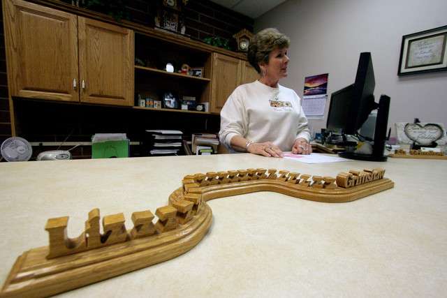 Gene Bigelow made this name plate for Uintah County human resources assistant Liz Grimshaw, pictured, after he asked her how she wanted her name spelled and she pronounced it with a long "Z." Bigelow worked for Uintah County building desks and cabinents for 18 years. He retired in January. (Photo: Geoff Liesik, Deseret News)