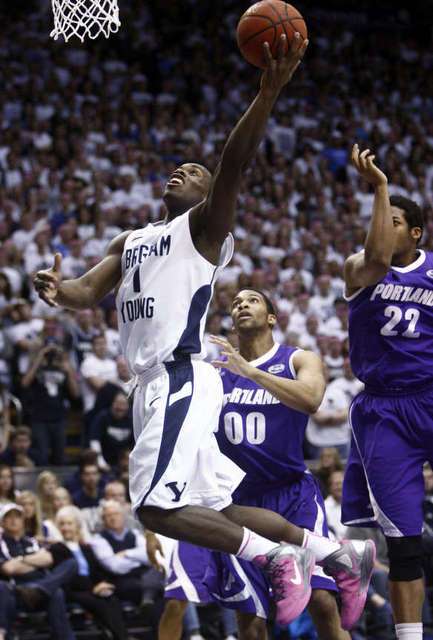 BYU's #1 Charles Abouo lays up a shot in front
of Portland's #00 Kevin Bailey and #22 Dorian
Cason. (Deseret News)
