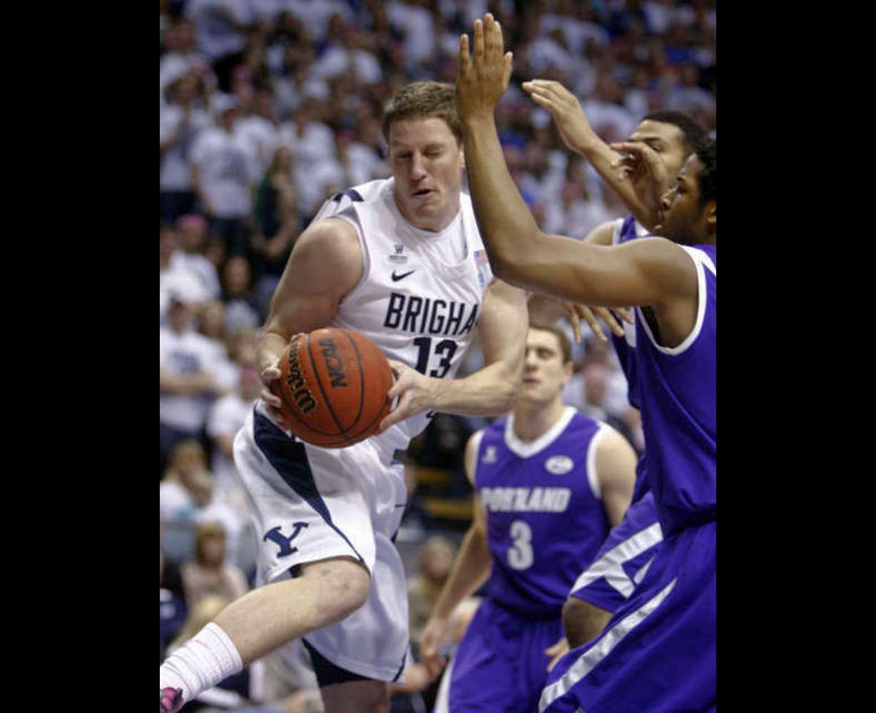 BYU's #13 Brock Zylstra grabs an offensive
rebound under the basket against Portland.
(Deseret News)