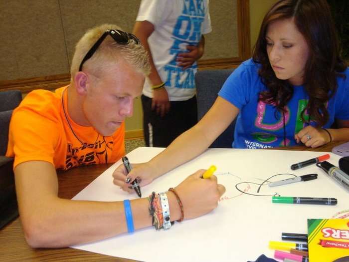 Utah Business Week students Riley Speth and
Jake Lewis creating a logo for their company
