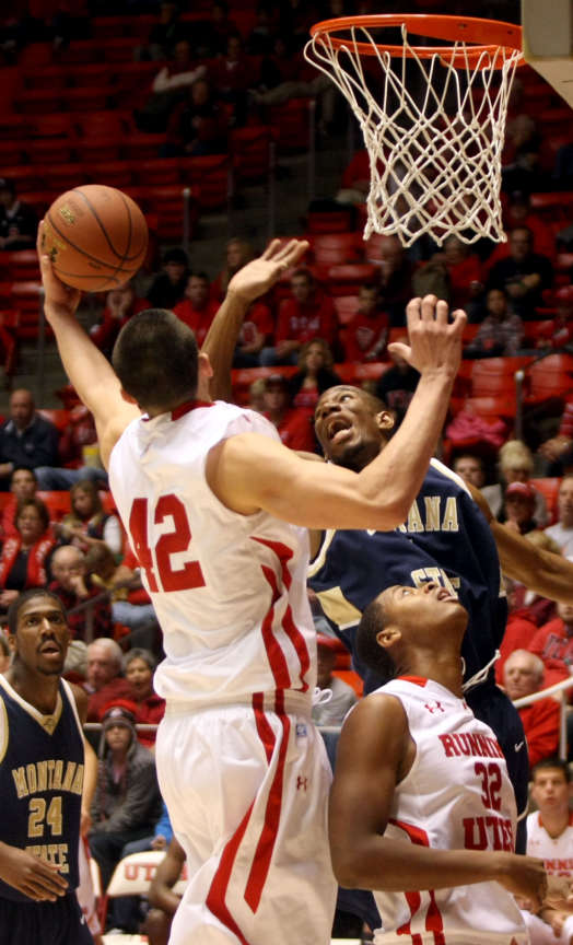 The University of Utah's Jason Washburn shoots as Montana State's Jamie Stewart blocks him in a mens basketball game at the Huntsman Center in Salt Lake City on Saturday, Nov. 19, 2011. Montana State's Tre Johnson and Utah's George Matthews watch. (Kristin Murphy, Deseret News)