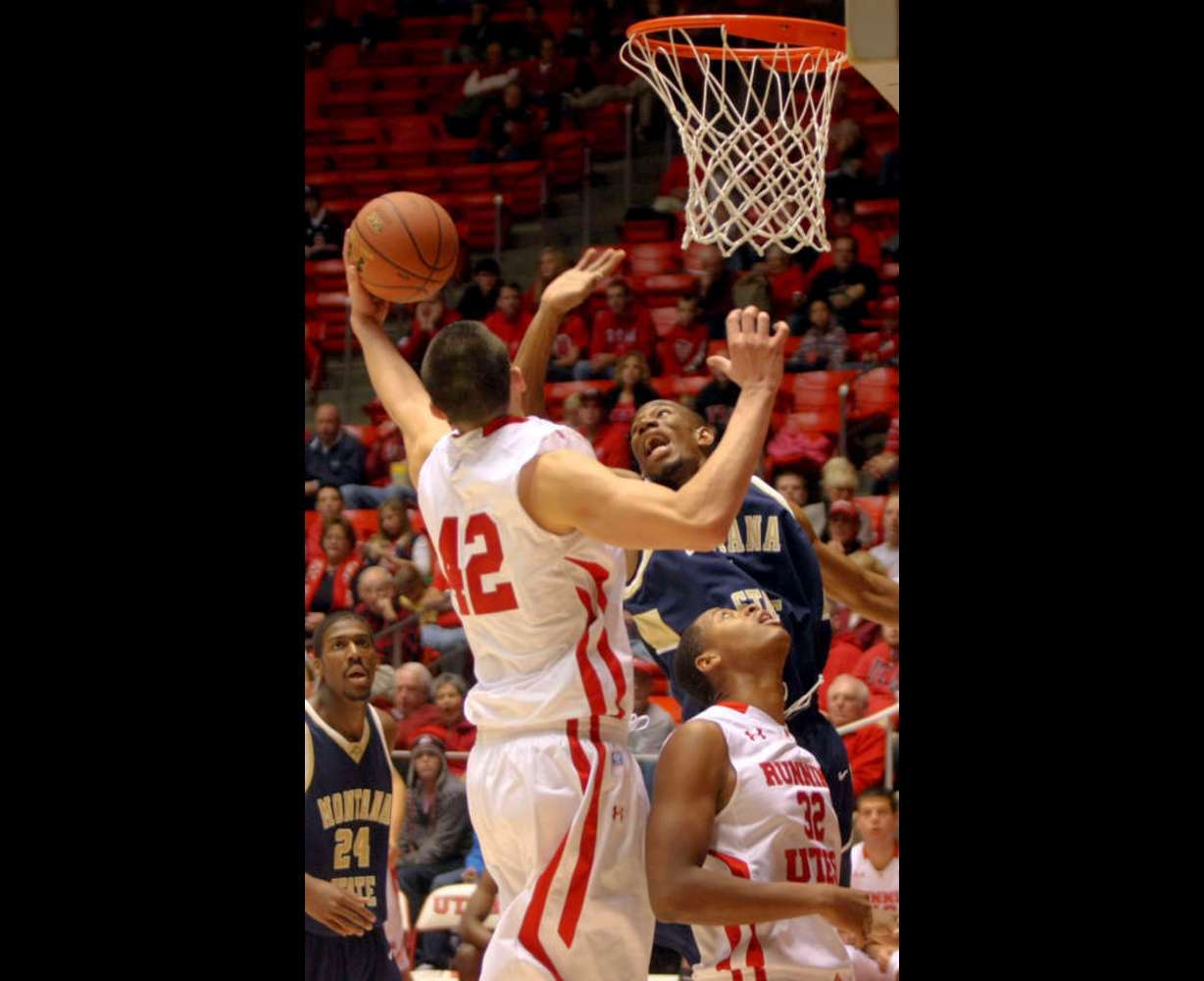 The University of Utah's Jason Washburn shoots as Montana State's Jamie Stewart blocks him in a mens basketball game at the Huntsman Center in Salt Lake City on Saturday, Nov. 19, 2011. Montana State's Tre Johnson and Utah's George Matthews watch. (Kristin Murphy, Deseret News)