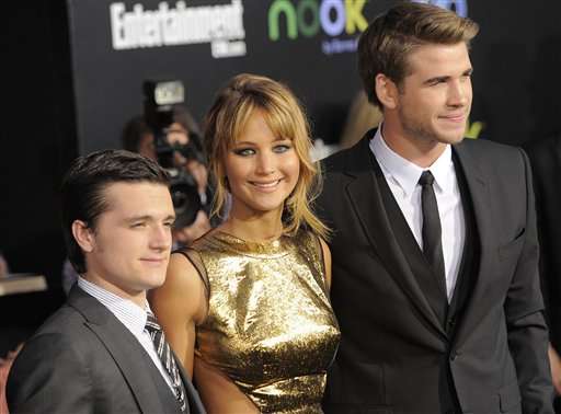 From left, Josh Hutcherson, Jennifer Lawrence and Liam Hemsworth arrive at the world premiere of "The Hunger Games" on Monday March 12, 2012 in Los Angeles. (AP Photo/Chris Pizzello)