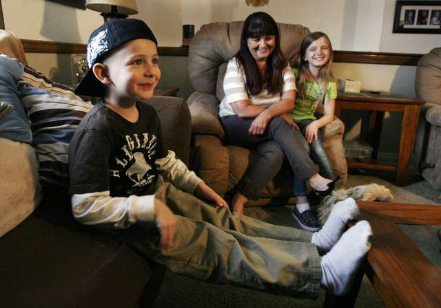 Six year old Colby Bertelsen called 911 to help his grandfather, Calvin Bertelsen, who had fallen during a seizure at home in West Valley City, Monday, March 12, 2012. In the background are his grandmother, Netta Bertelsen and his sister Shyan Bertelsen. (Photo: Ravell Call, Deseret News)